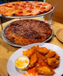 Buffalo wings and two pies